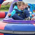 Kids sitting in bumper carts